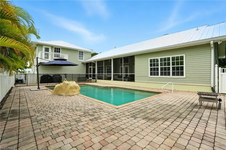 View of swimming pool with a patio area and a sunroom