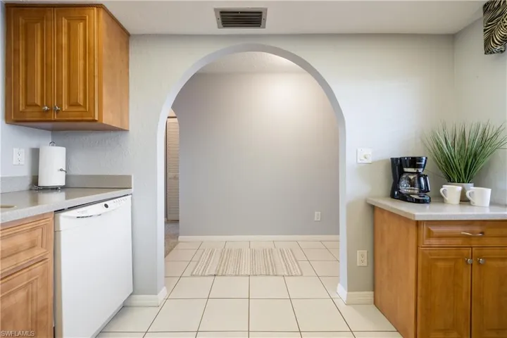 Kitchen featuring light wood cabinetry and light-toned countertops