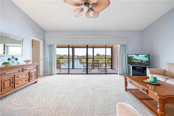 Expansive living area with neutral carpeting and light blue walls