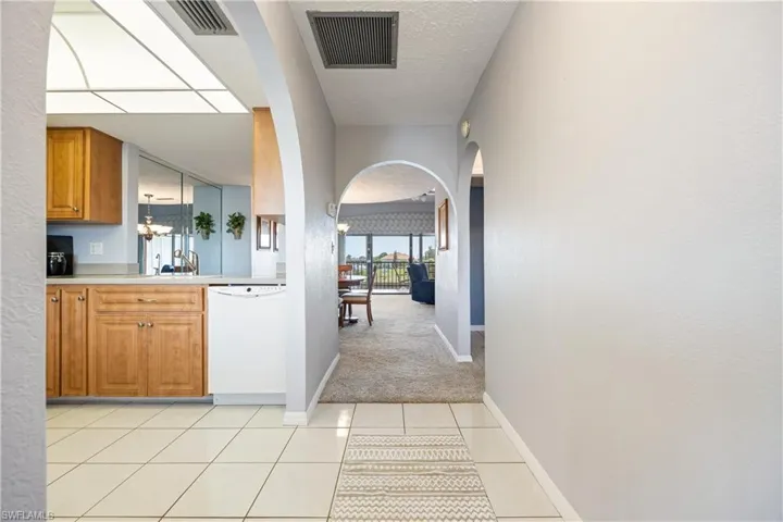 Entryway featuring large format tile flooring and multiple arched openings
