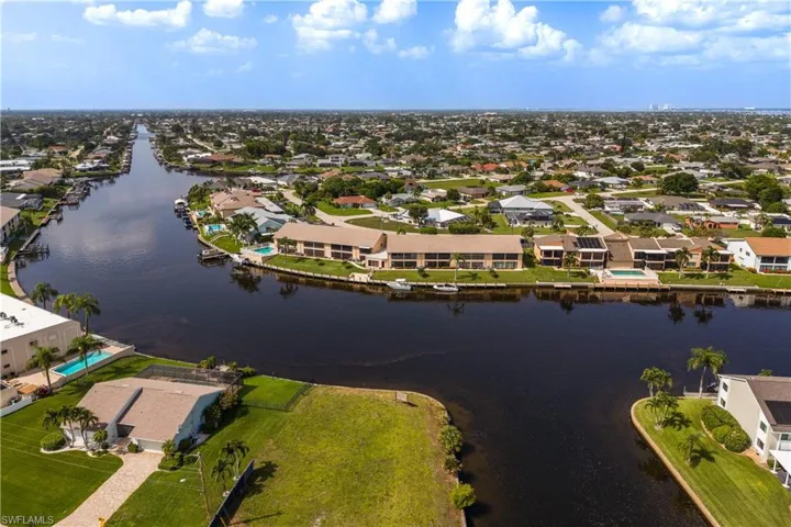 Expansive waterfront property featuring direct canal access, a private boat dock, and a tropical landscape