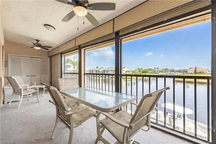 Screened balcony featuring expansive water frontage