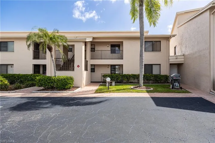 Multi-level stucco exterior with private balconies and wrought iron railings