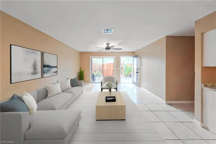Living room with ceiling fan and light tile patterned flooring