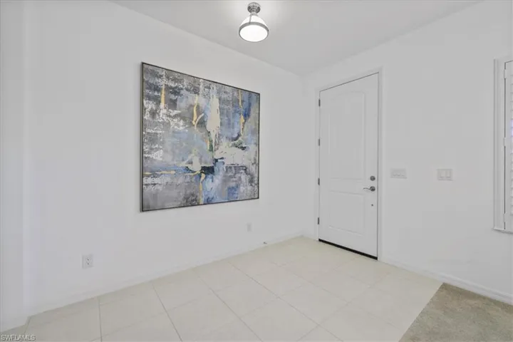 Foyer entrance featuring baseboards and light tile patterned flooring