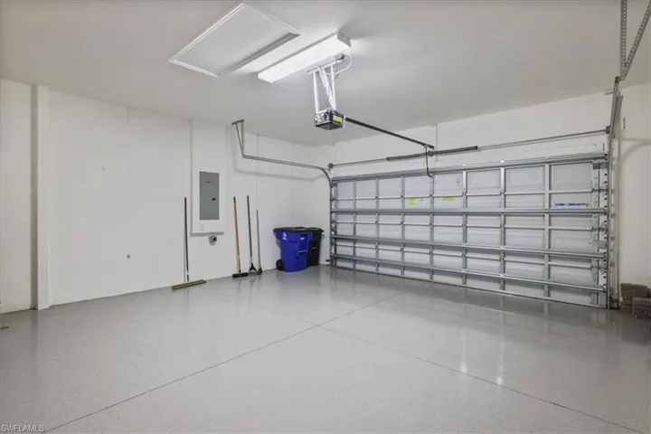 Garage with electric panel and a garage door opener