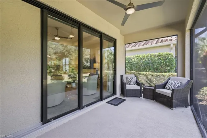 Sunroom featuring ceiling fan and a patio