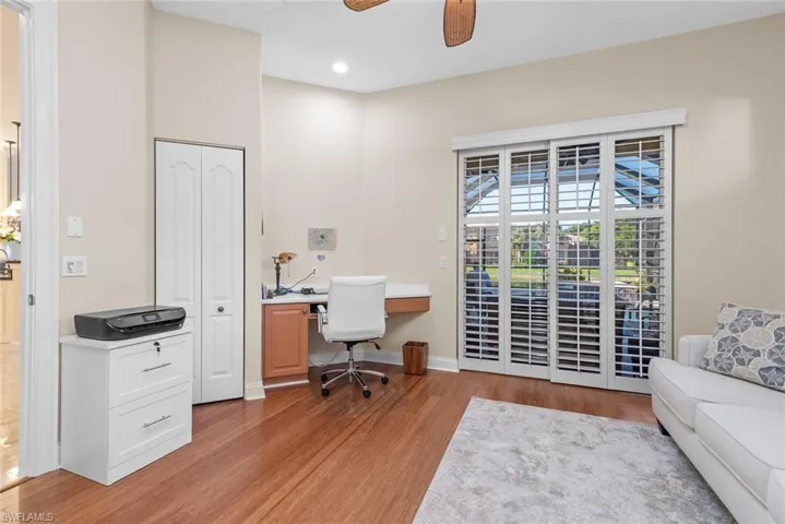 Office with ceiling fan and light wood-type flooring