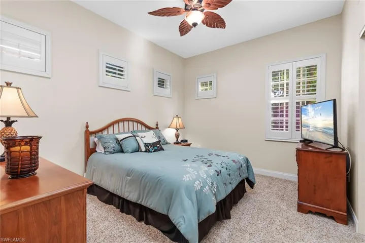Carpeted bedroom with ceiling fan
