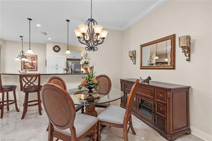 Dining space featuring a chandelier and ornamental molding