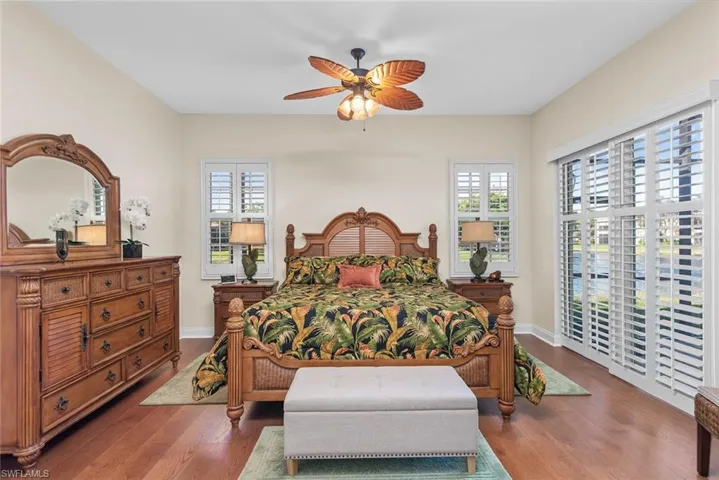 Bedroom with ceiling fan and dark hardwood / wood-style floors