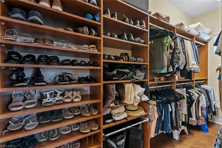 Spacious closet featuring hardwood / wood-style flooring
