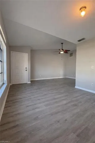 Spare room featuring wood finished floors and a ceiling fan