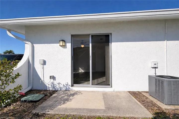 Entrance to property featuring a patio area and stucco siding