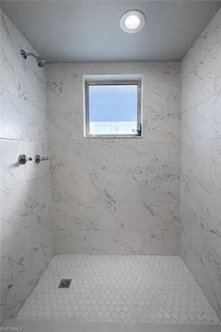Full bathroom with a shower stall