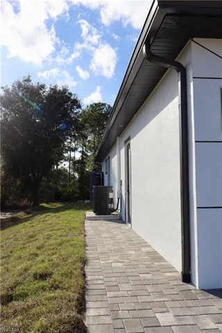 View of home's exterior featuring a lawn and stucco siding