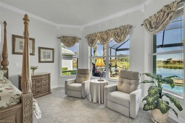 Carpeted bedroom featuring ornamental molding and baseboards