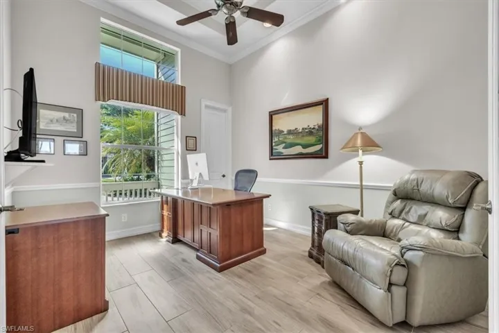 Office with crown molding, plenty of natural light, wood tiled floors, and ceiling fan