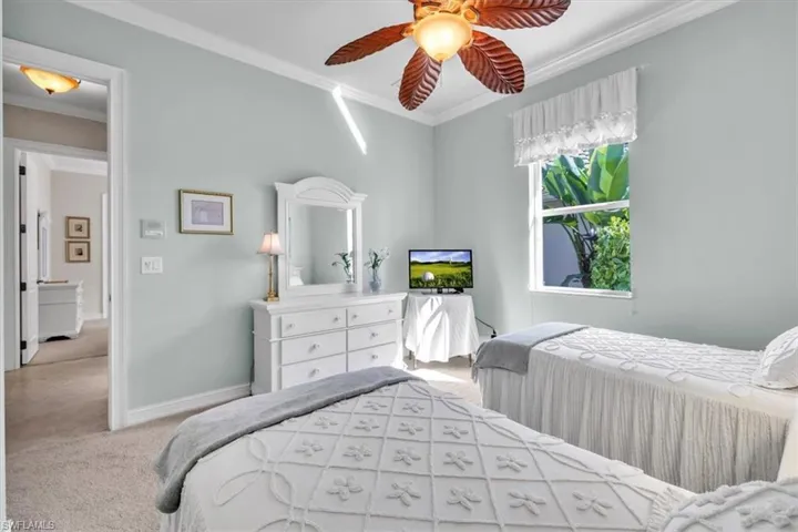 Bedroom with carpet, ornamental molding, and ceiling fan