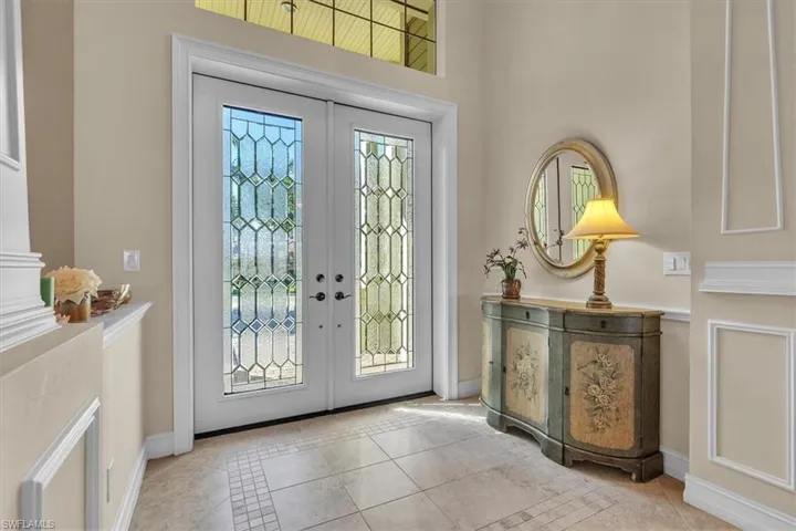 Entryway featuring french doors and light tile patterned floors