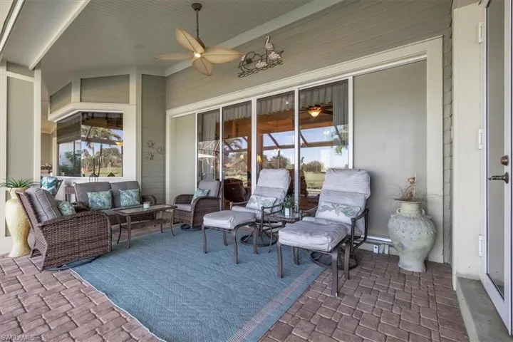 View of patio featuring ceiling fan, baseboard heating, and an outdoor hangout area