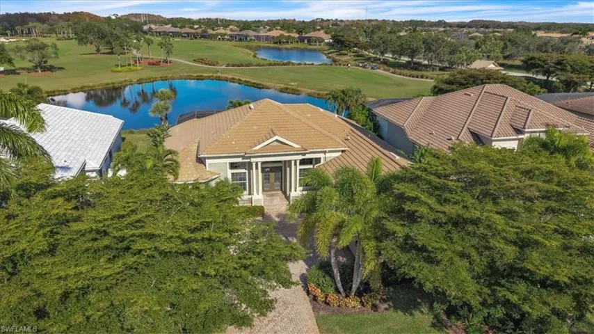 View from above of property featuring a nearby body of water and a golf club