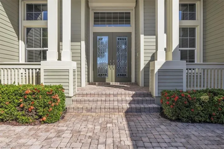 Doorway to property featuring a porch and french doors