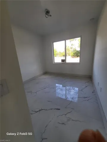 Empty room with baseboards and light marble finish flooring