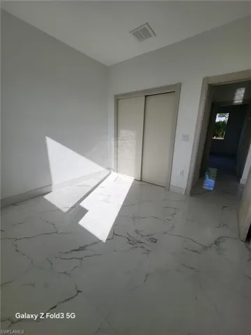Unfurnished bedroom with baseboards and a closet
