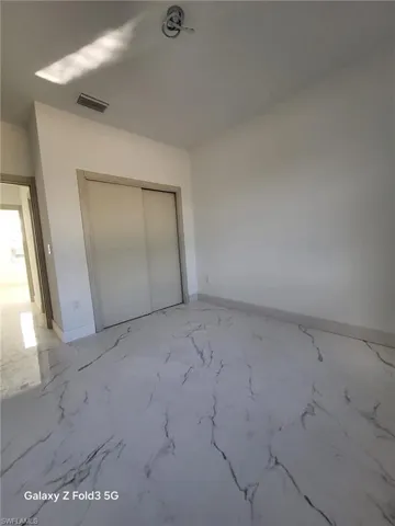 Unfurnished bedroom with baseboards and a closet