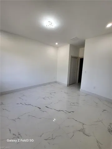 Unfurnished room featuring baseboards and recessed lighting
