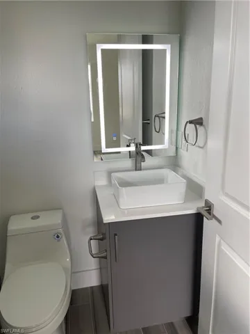 Bathroom with vanity and a textured wall