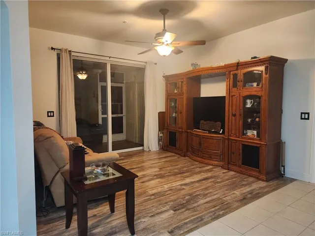 Living room featuring ceiling fan and hardwood / wood-style floors
