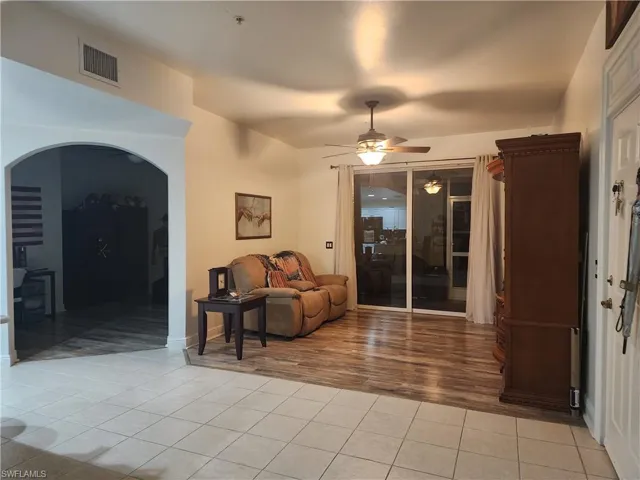 Tiled living room with ceiling fan