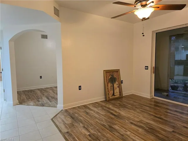 Empty room with light hardwood / wood-style flooring and ceiling fan