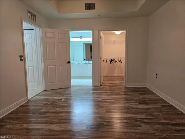 Spare room with dark hardwood / wood-style floors