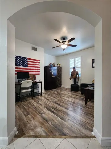 Living room featuring hardwood / wood-style flooring and ceiling fan