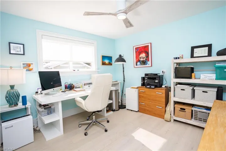 Home office featuring wood finished floors and ceiling fan