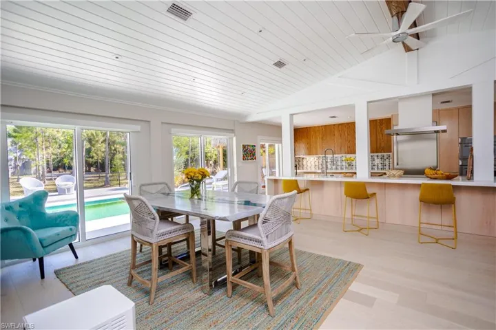 Dining space with wooden ceiling, ceiling fan, vaulted ceiling, and light wood-style floors