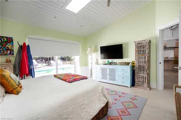 Bedroom with wood finished floors, a skylight, wooden ceiling, and vaulted ceiling