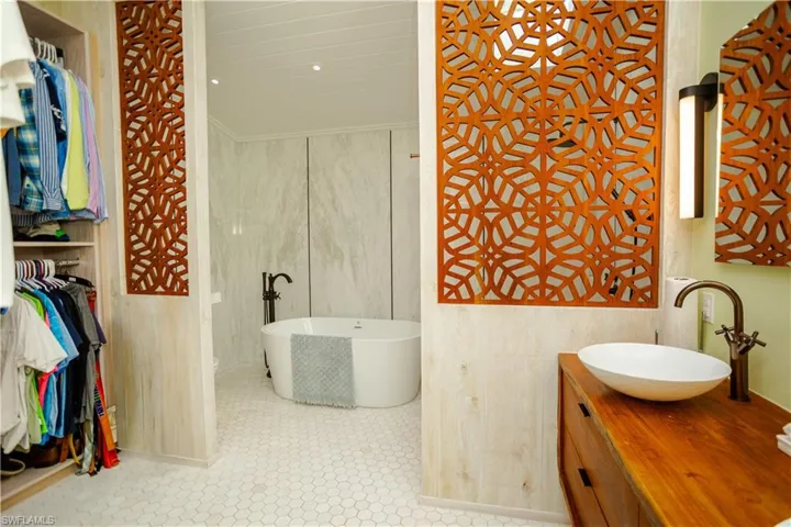 Bathroom featuring a soaking tub and vanity