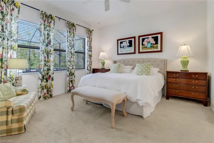 Bedroom featuring ceiling fan and light colored carpet