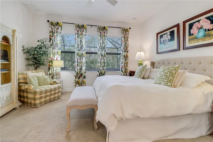 Carpeted bedroom featuring ceiling fan