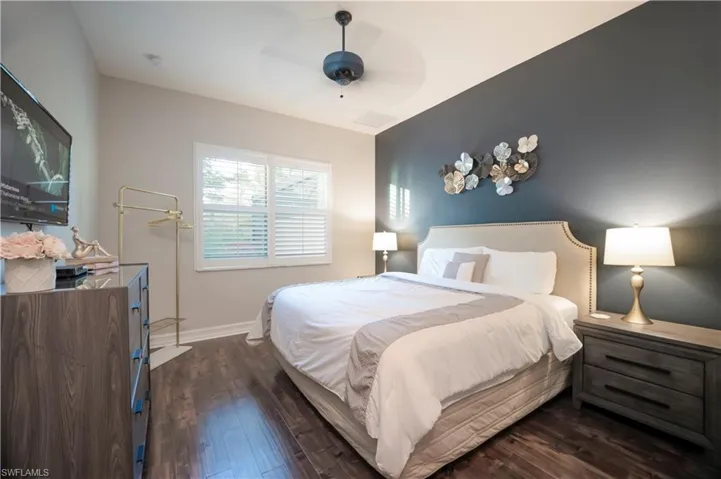 Bedroom featuring dark wood-type flooring and ceiling fan