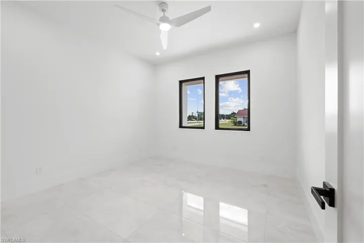 Empty room with recessed lighting and a ceiling fan