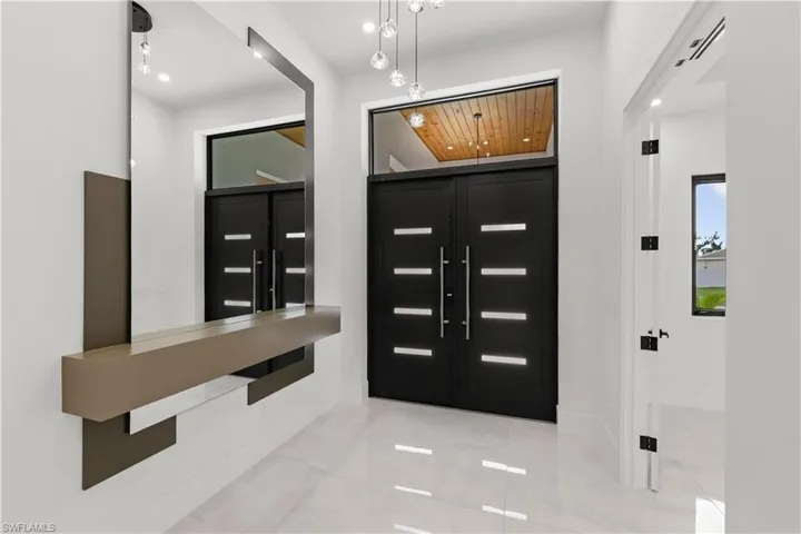 Entryway with recessed lighting and light tile patterned floors