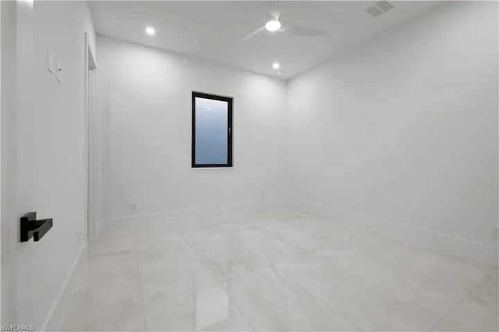 Spare room with a ceiling fan, recessed lighting, and light tile patterned flooring