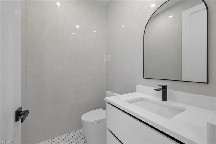 Bathroom with vanity and tile walls