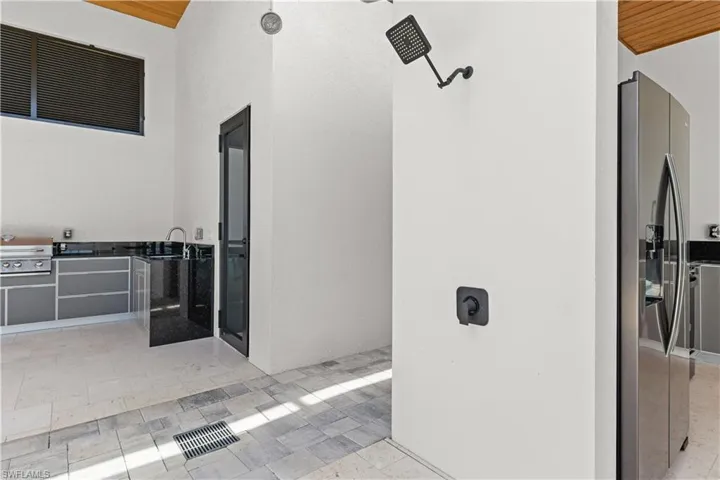 View of patio with an outdoor kitchen and a sink