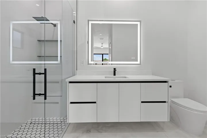 Bathroom featuring vanity and a stall shower
